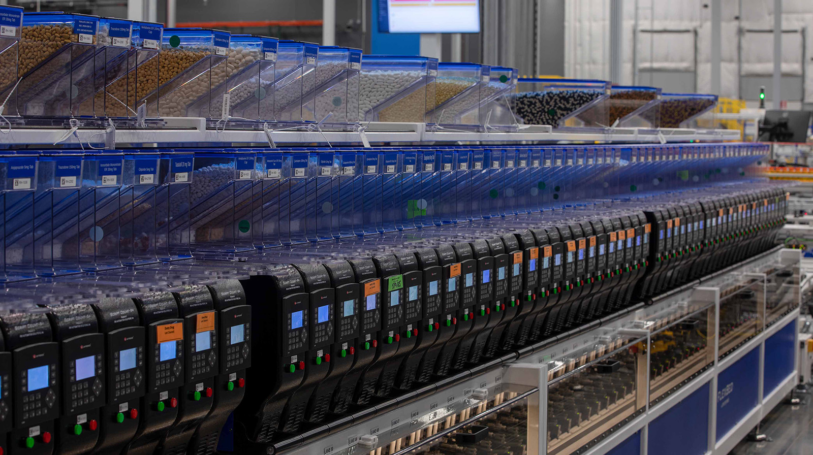 Associate working with pharmacy technology inside the Central Fill facility